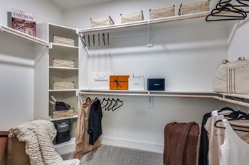 Spacious walk-in closets with custom wood shelving